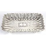 A Victorian silver dish of rectangular form with shell and c-scroll decoration on four spherical