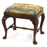 An 18th century and later stool with cabriole legs, an X-stretcher and later embroidered drop-in
