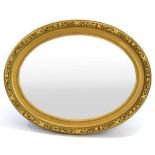 A late 19th century giltwood wall mirror, the oval plate 87 x 63 cm within a ball work and foliate
