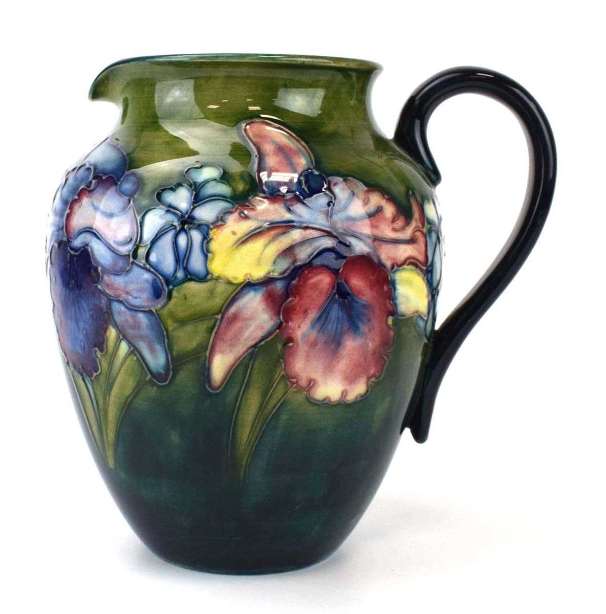 A Moorcroft water jug of ovoid form decorated with stylised flowers on a shaded green ground, h.