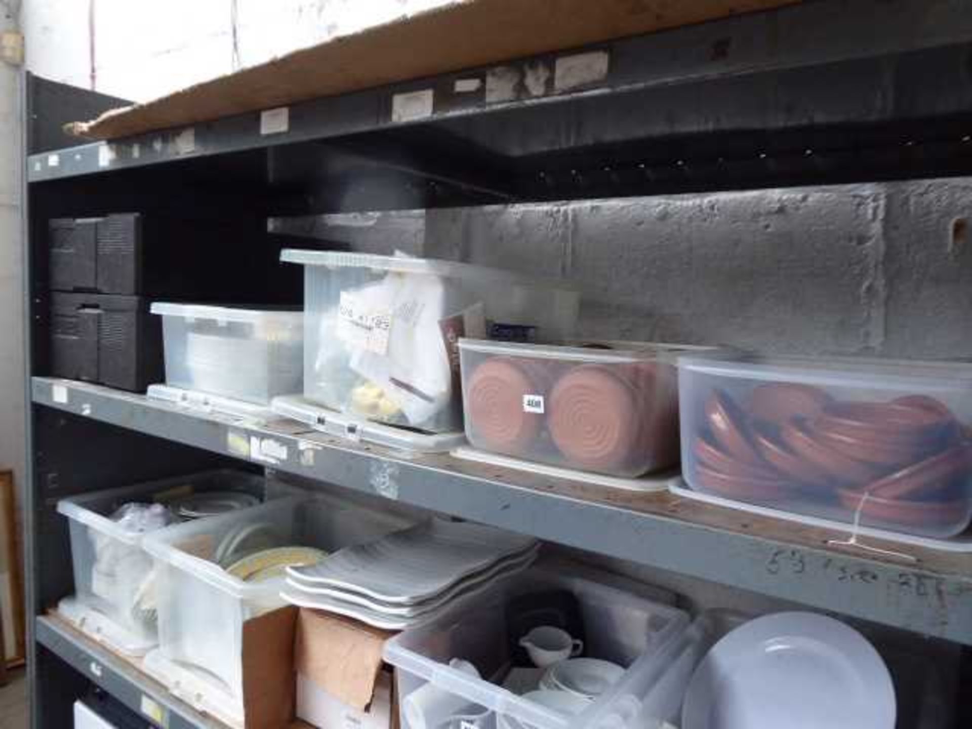 Shelf with 4 boxes of tapas type dishes, disposable containers, jugs, glassware, etc