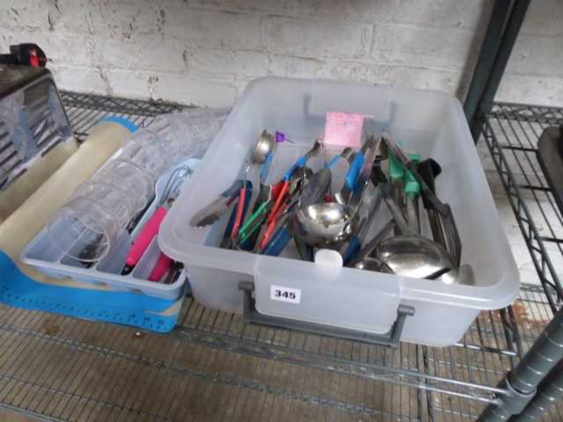Plastic tray containing assorted utensils, small tray with cutlery and baker's silicon mats