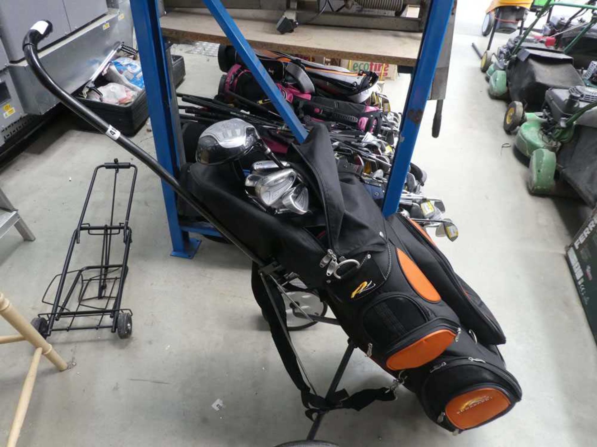 Power caddy orange and black golf bag and a qty of Mizuno and Dunlop clubs