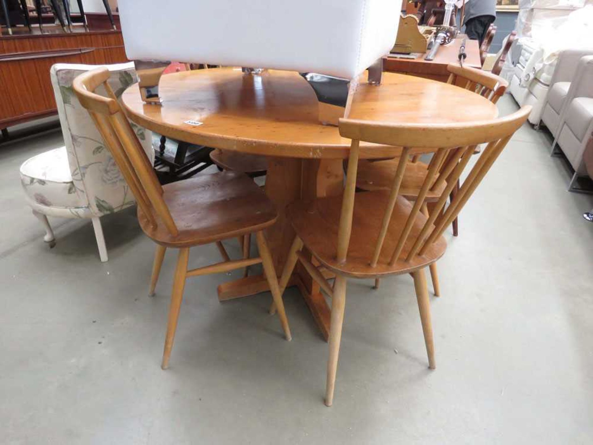 Circular pine table plus 4 stickback Ercol chairs