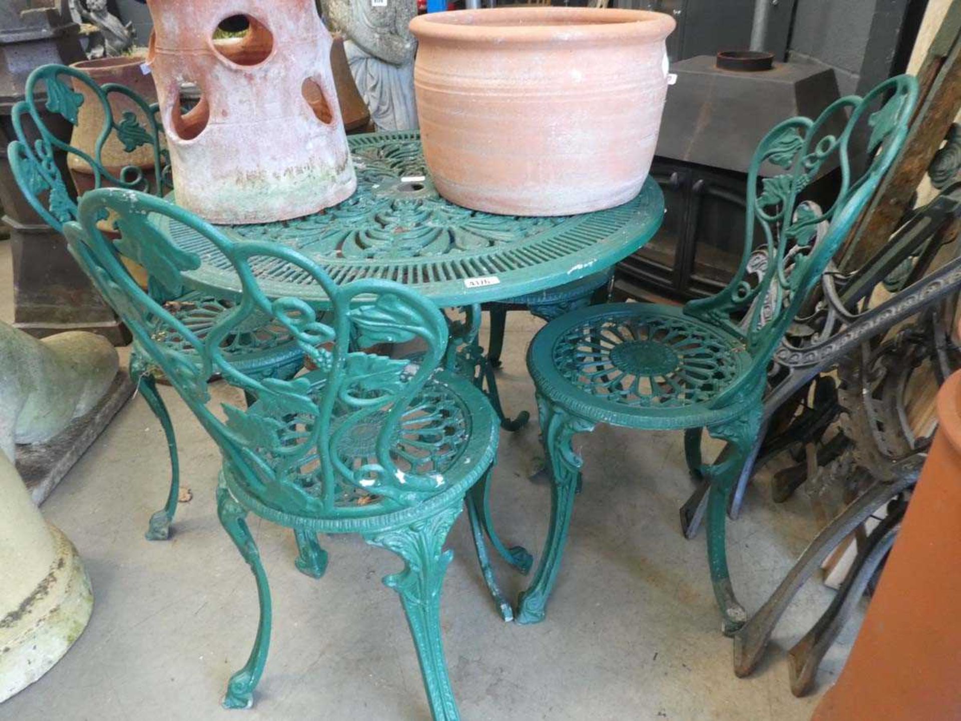 Green round metal garden table with 4 matching chairs