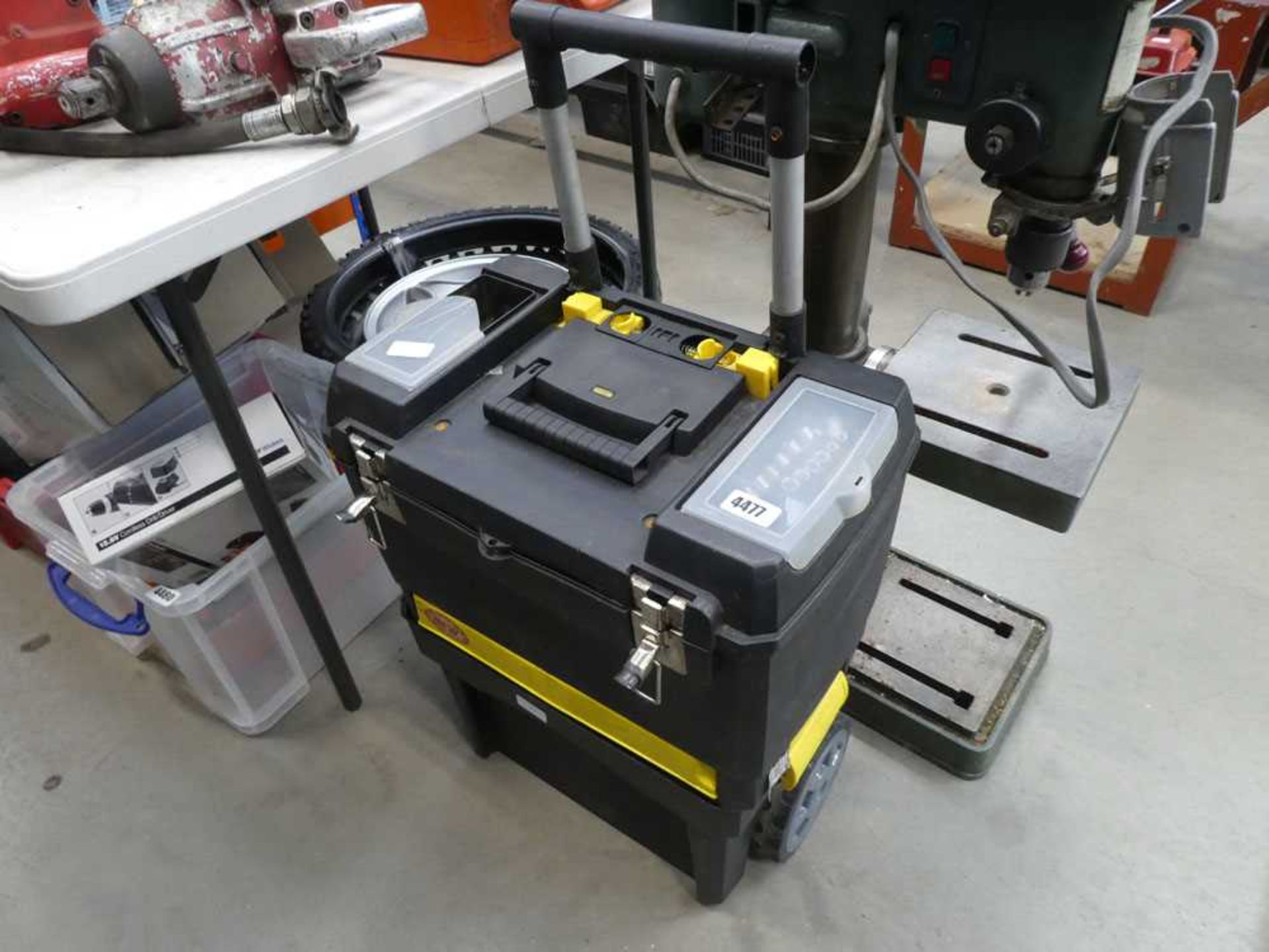 Wheeled plastic toolbox with small quantity of various tools