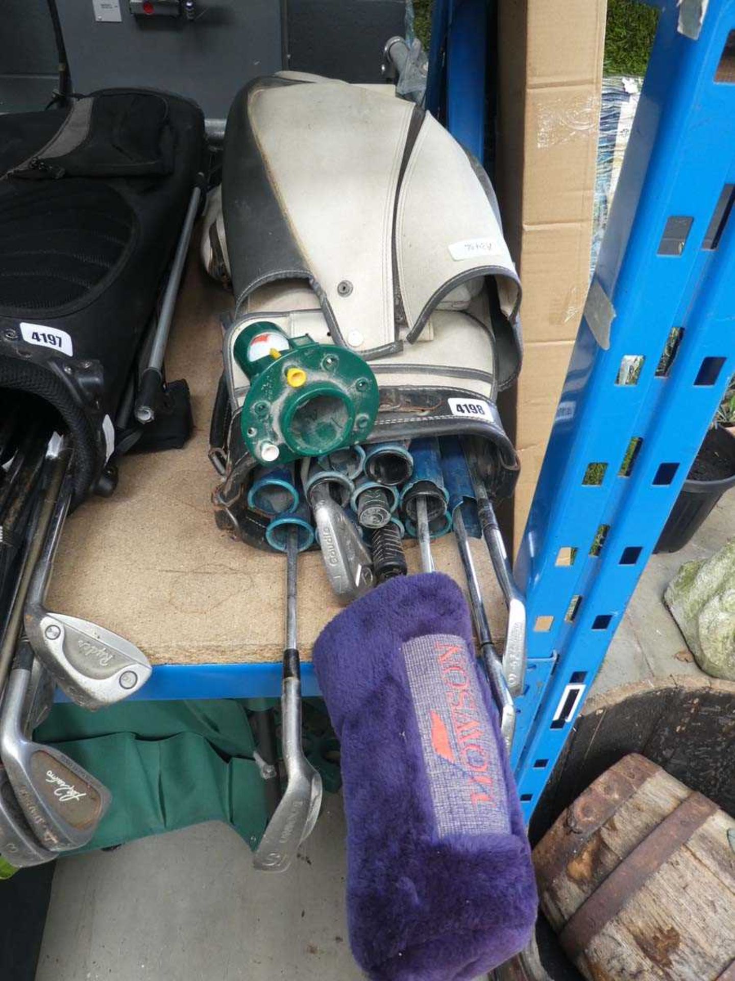 Cream golf bag with a small quantity of assorted clubs