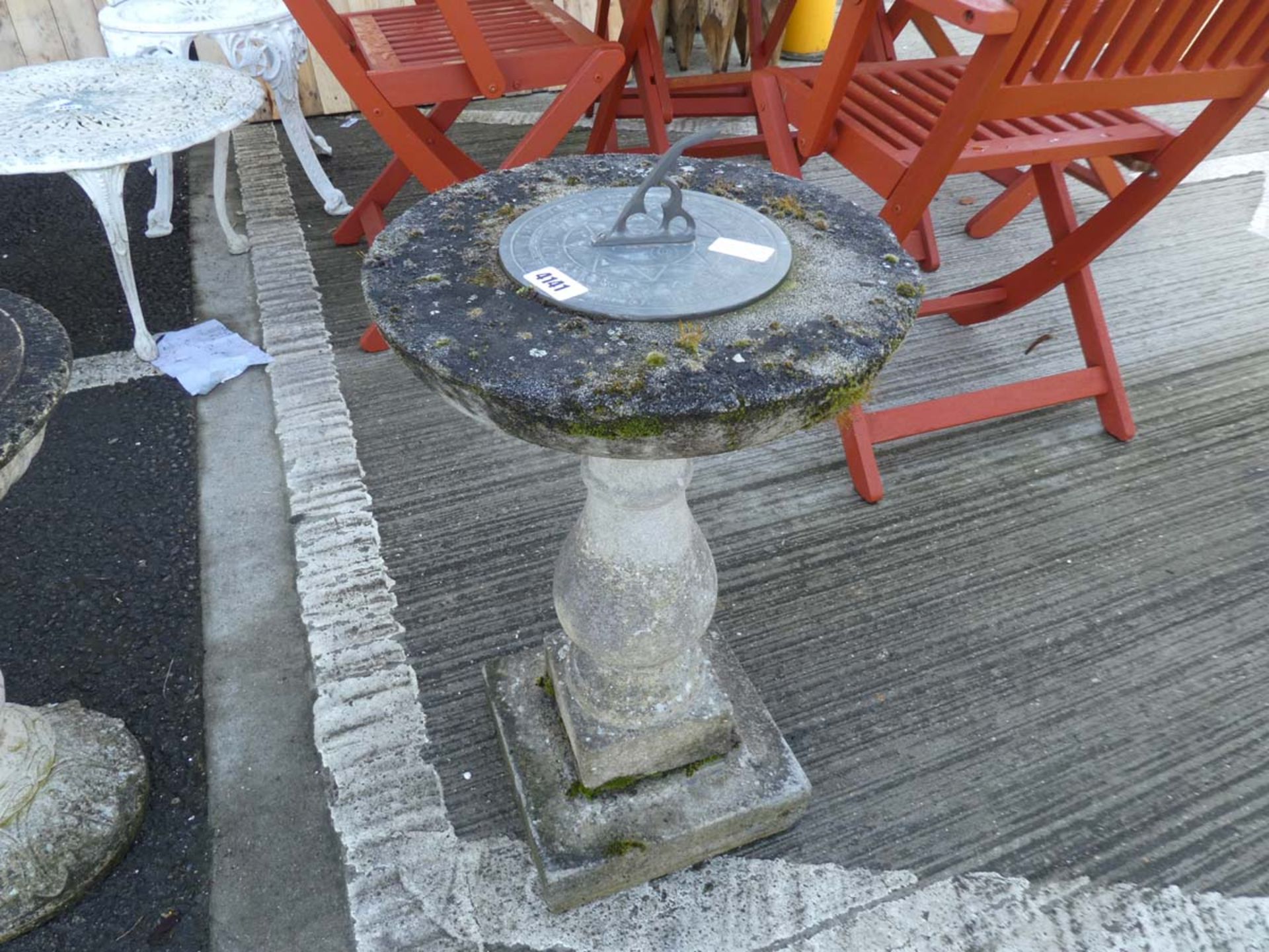 Round sun dial on plinth