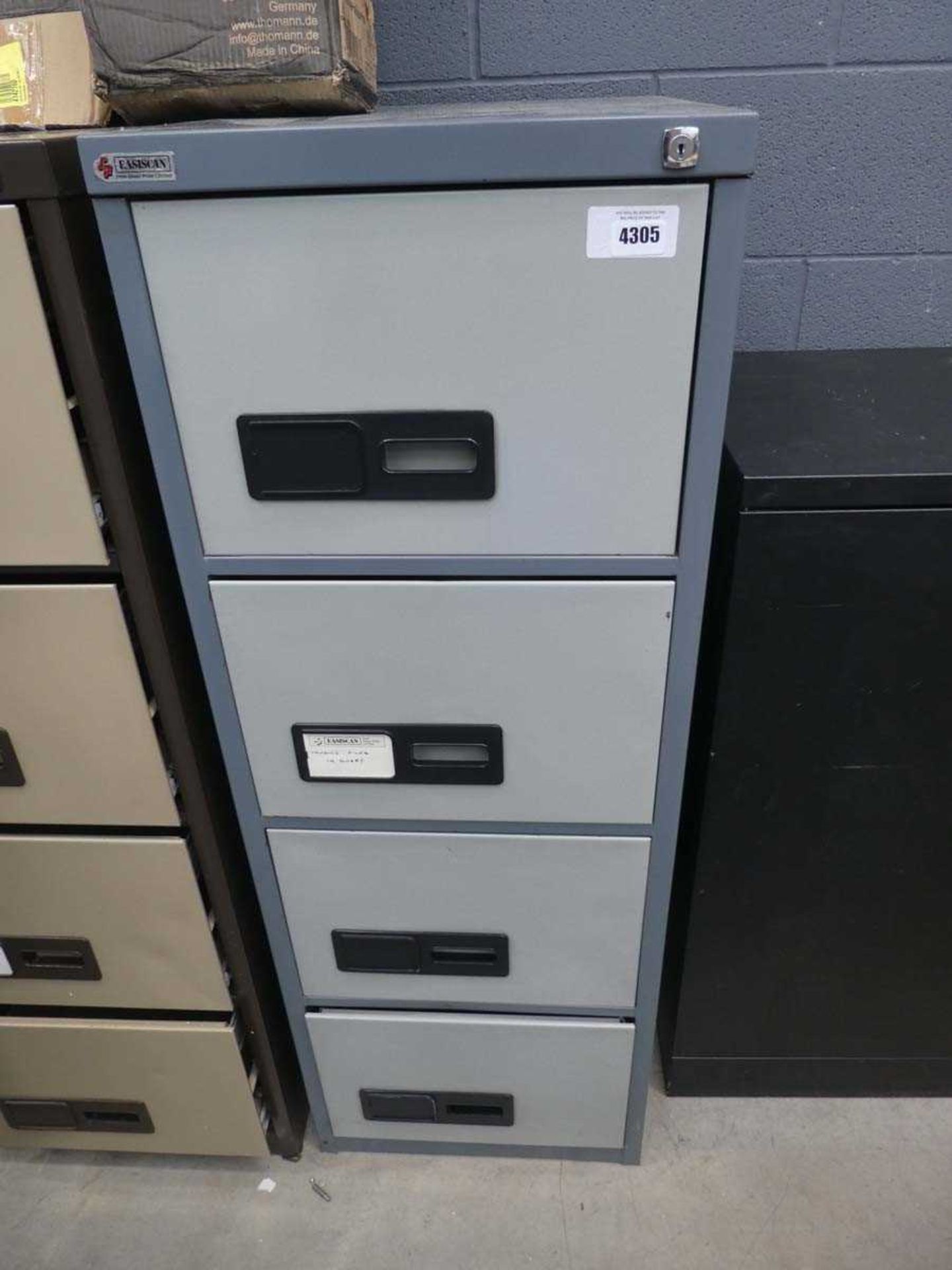 A grey 4 drawer metal filing cabinet