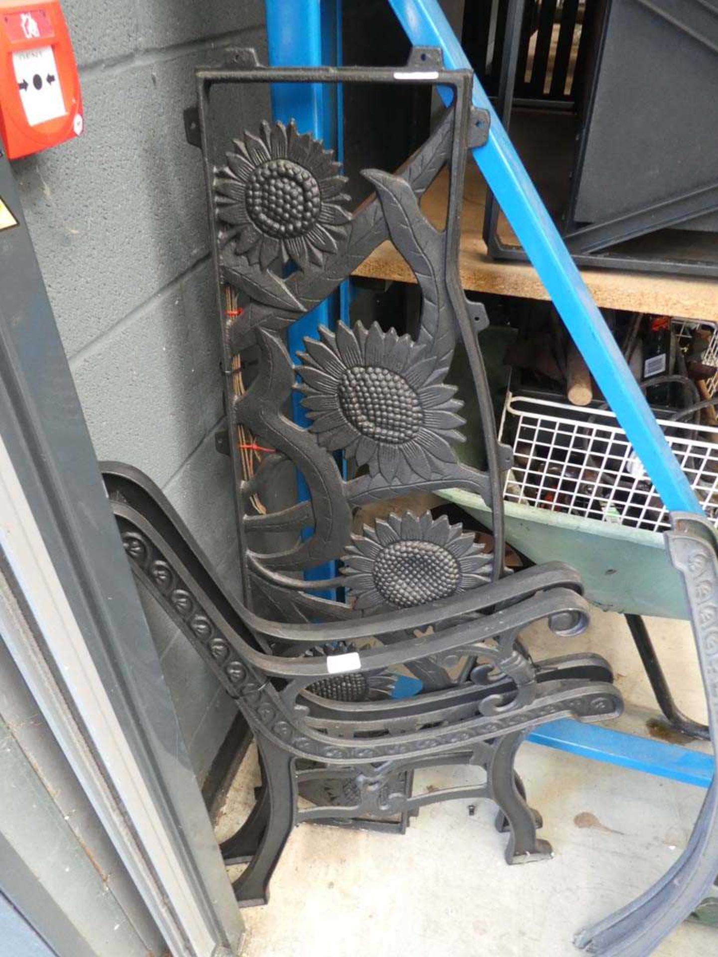 Black metal sunflower patterned bench back with two metal bench ends