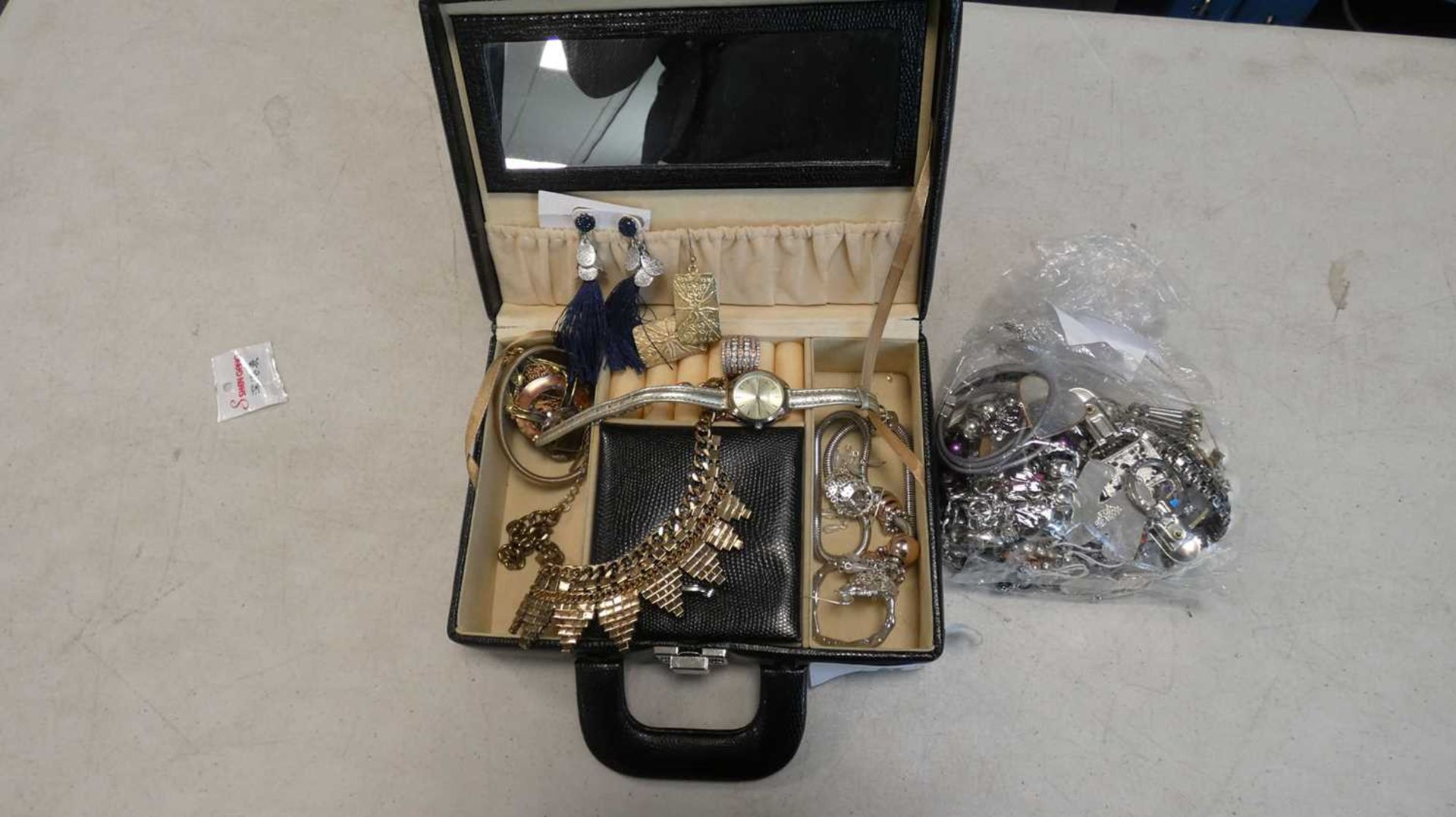 Clear bag containing white metal and costume jewellery items and case containing other costume