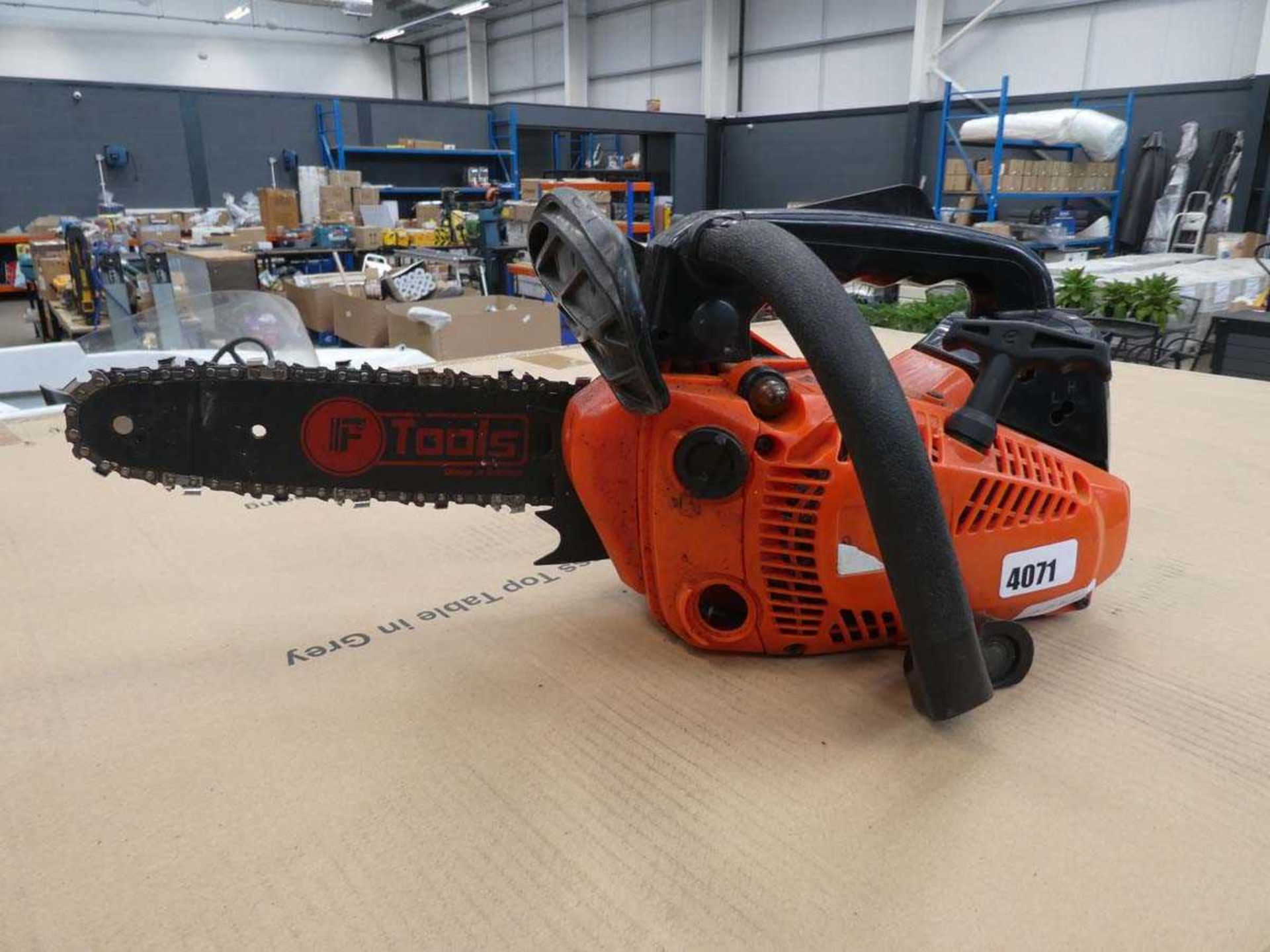 Orange petrol powered chainsaw