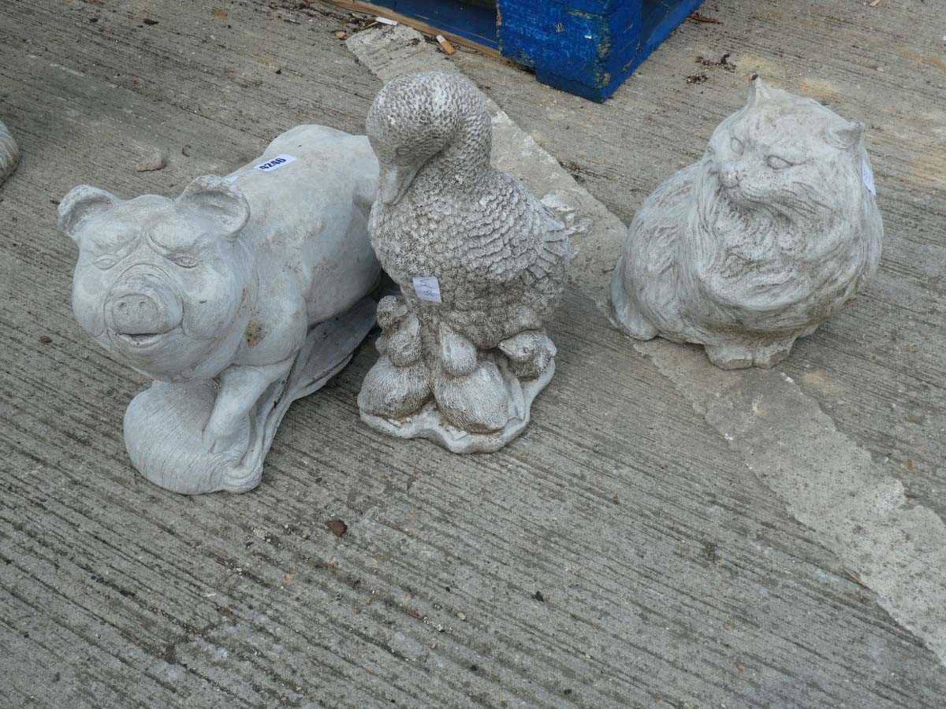 Concrete statue of a pig, duck, and cat