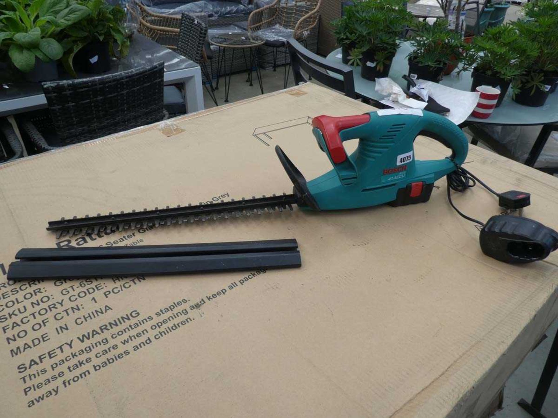 Bosch battery powered hedge cutter with one battery and charger