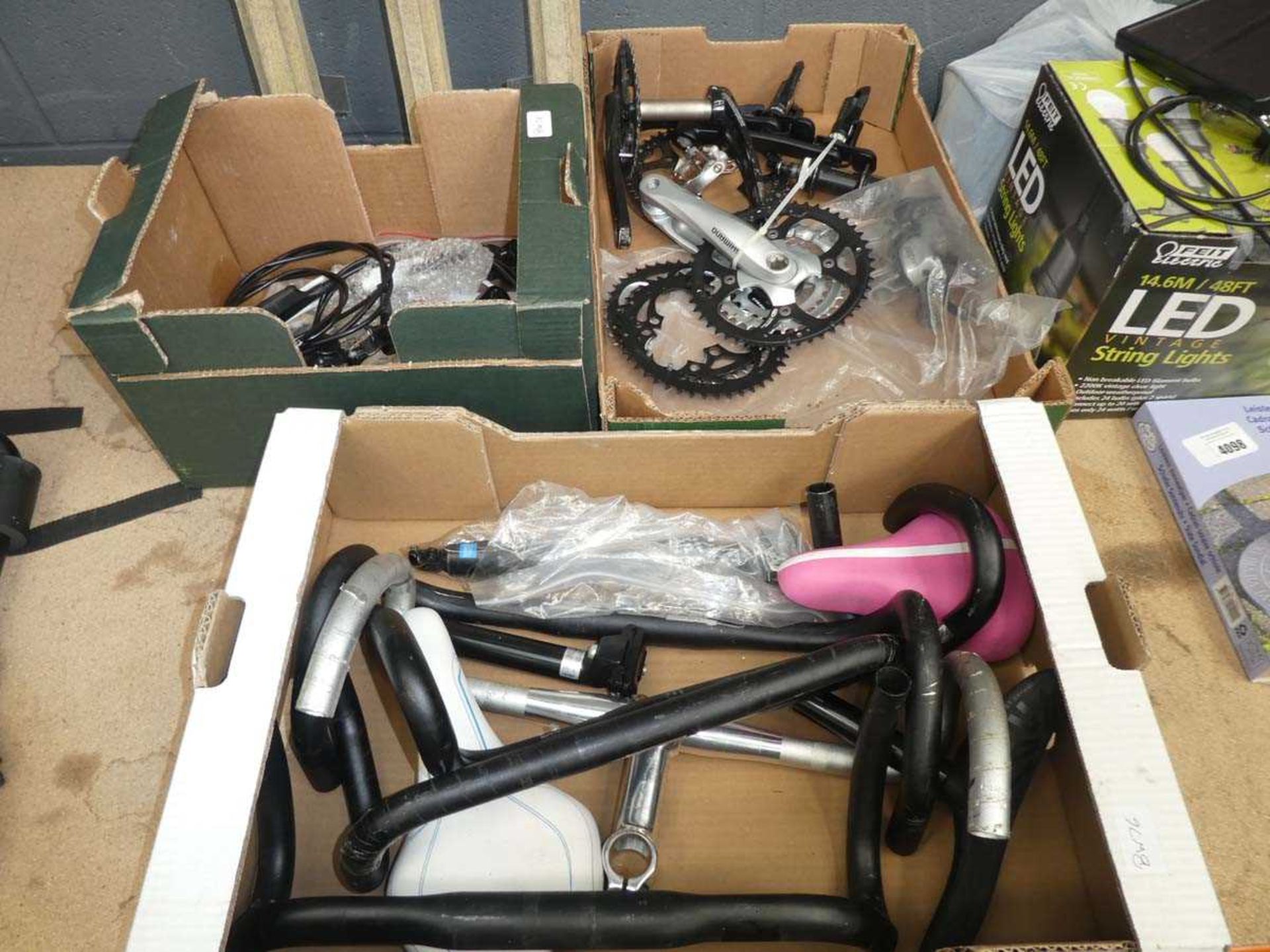3 boxes of assorted bike parts