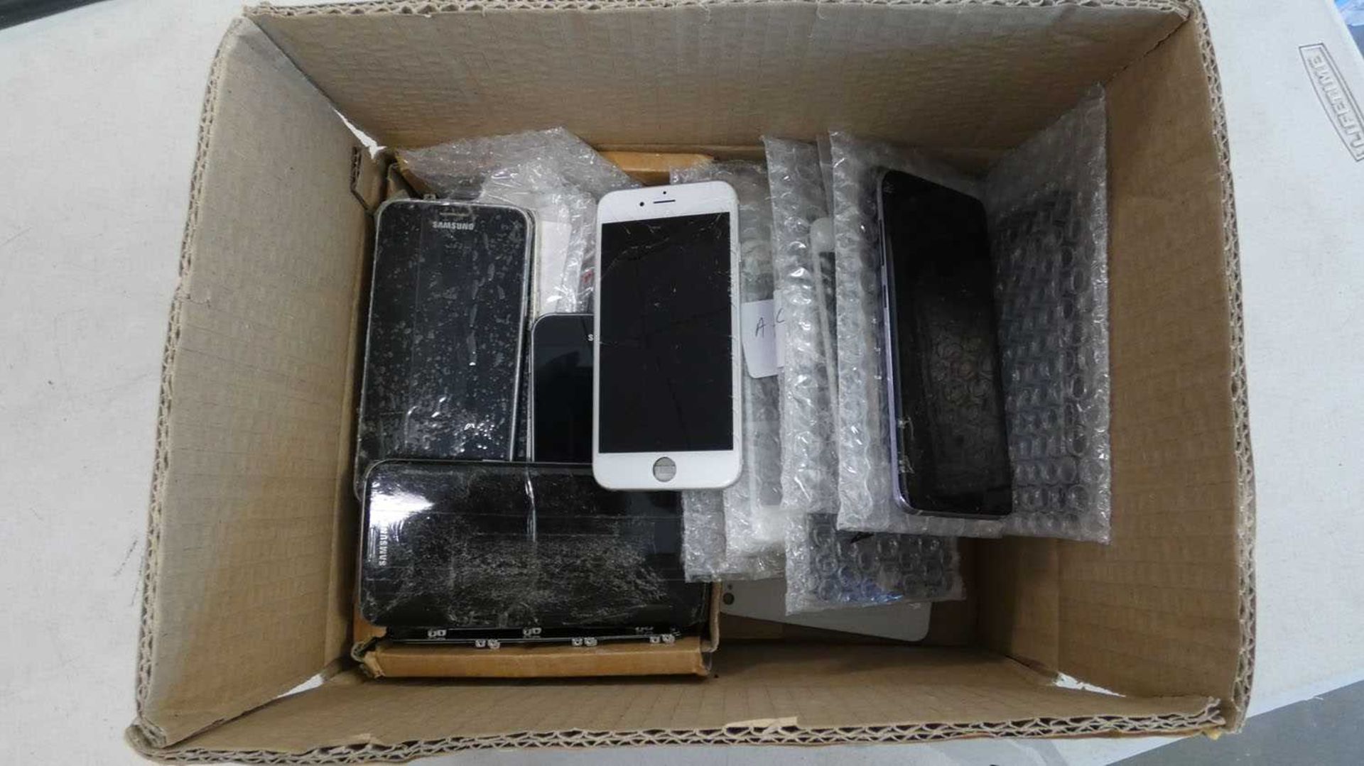 Box of assorted smartphone parts, phones, etc. (AF, some cracked, some may be locked to accounts)