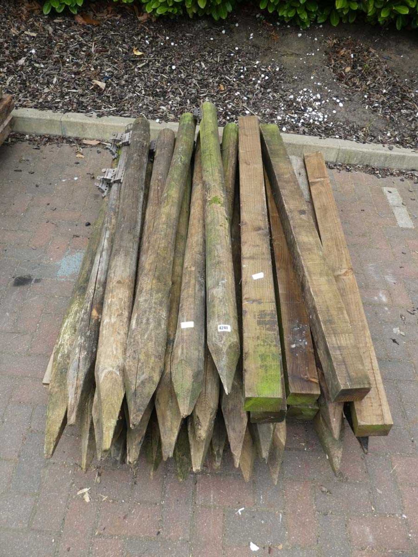 Large pallet of round and square wooden posts