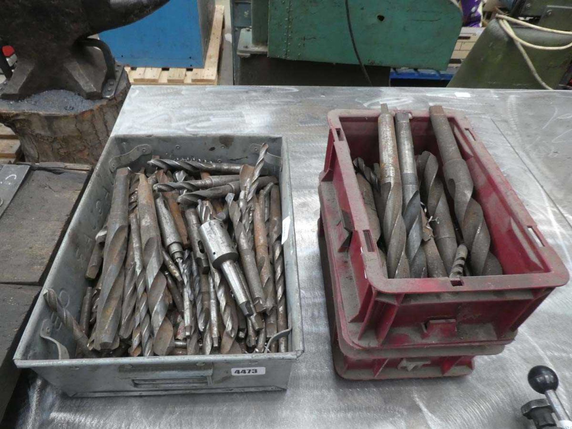 Metal tin and 2 plastic tins of engineering drill bits