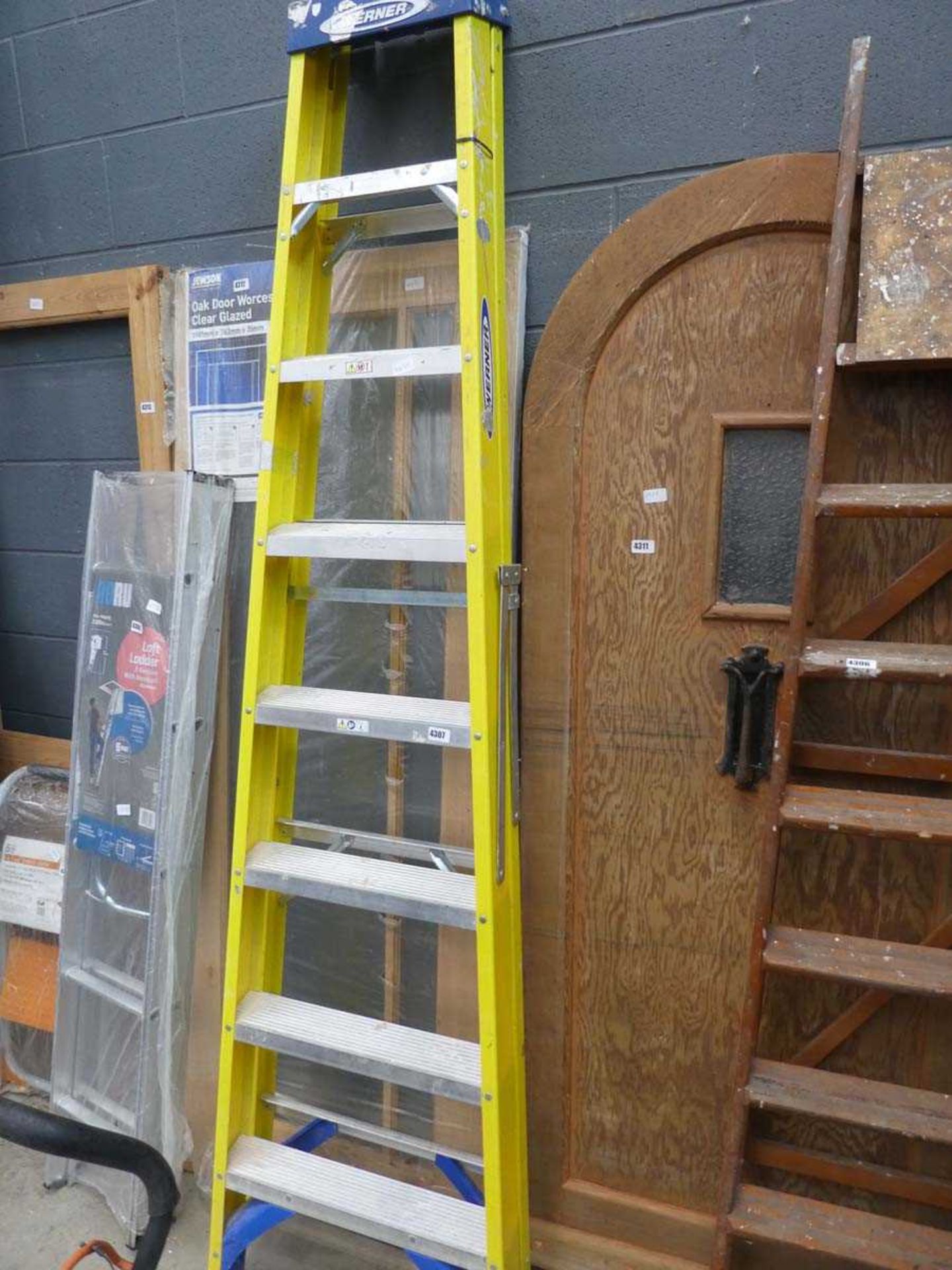 Eight tread Werner yellow and silver electrician's style ladder