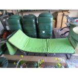 Pair of grey collapsible sunbeds with green cushions