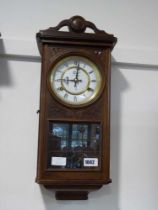 Dark oak cased wall clock by The Time MFG Co.