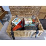 Wicker basket containing vintage tins