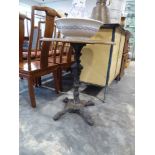Small circular cafe type table on ornate single pedestal 4 star cast iron base