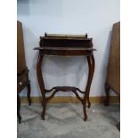 Mahogany side table with brass trim and gallery section