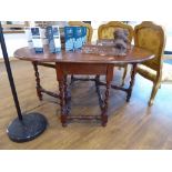 Dark oak drop leaf dining table on twisted base