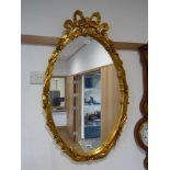 Oval wall mirror in ornate gilt frame