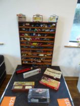 Die cast display stand containing die cast tradesman's vehicles, buses, fire engines, etc. with