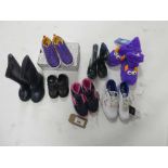A bag containing 7 pairs of children's shoes in various styles and sizes