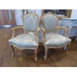 Pair of distressed gilt framed open armchairs with blue and silver upholstered seats and backs