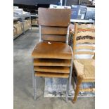 Stack of 4 tubular metal framed chairs with ply seats and backs