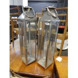 Modern pair of chrome and glass candle holders