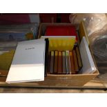 Box containing various sized notebooks