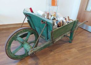 19th Century French provincial oak wheelbarrow containing a hamper of fine food and wines. All