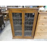 Dark oak display cabinet with leaded glass doors