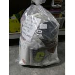 Bag containing various household goods, including draught excluders, plant covers, bathroom