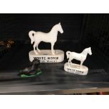 Graduated pair of White Horse Scotch whiskey ornaments together with a further small Black Horse