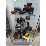 3 shelves of vintage camera equipment incl. Praktica camera bodies, Kodak Brownies, various lenses