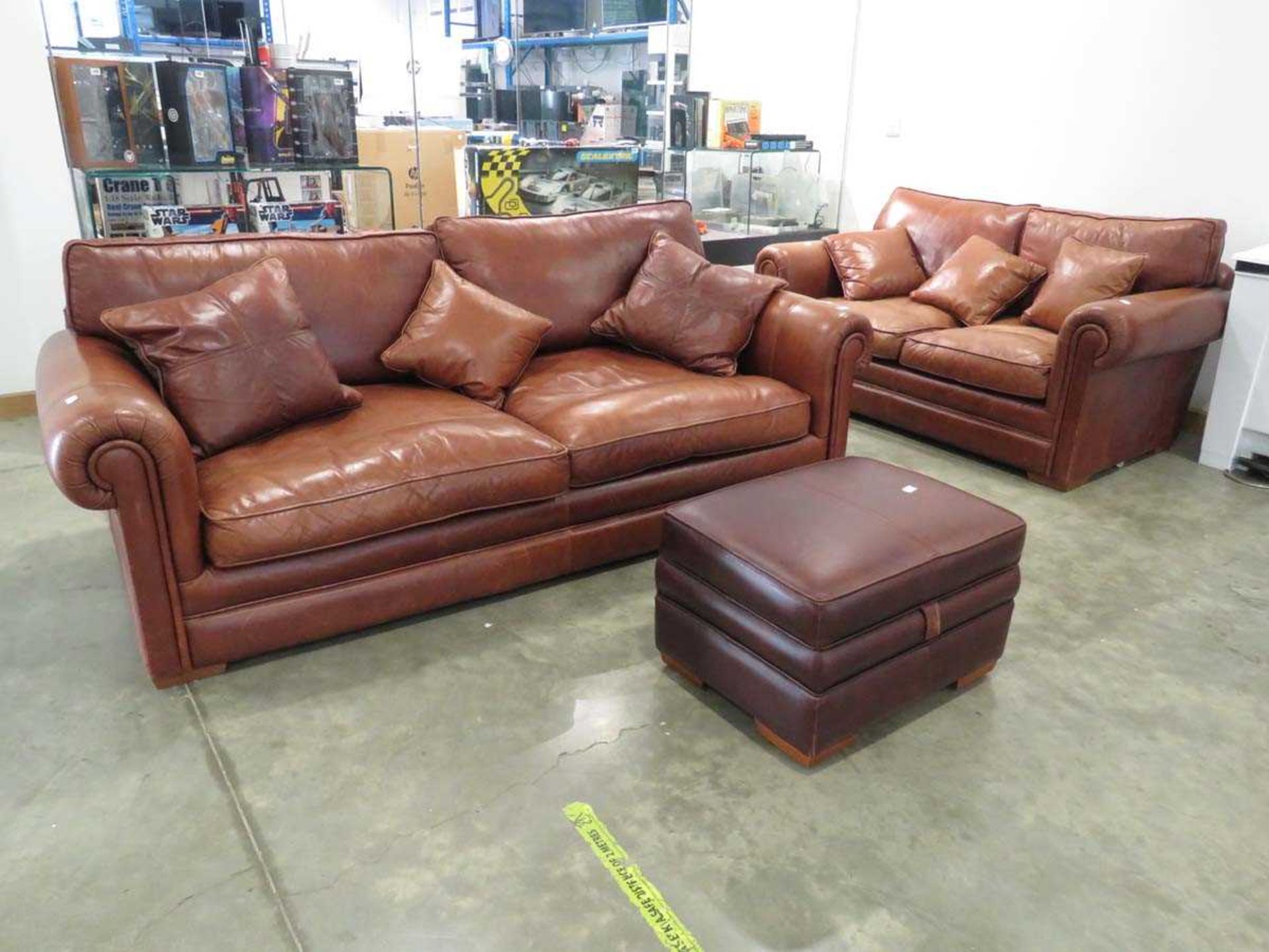 Brown leather three seater sofa plus a matching two seater and footstool