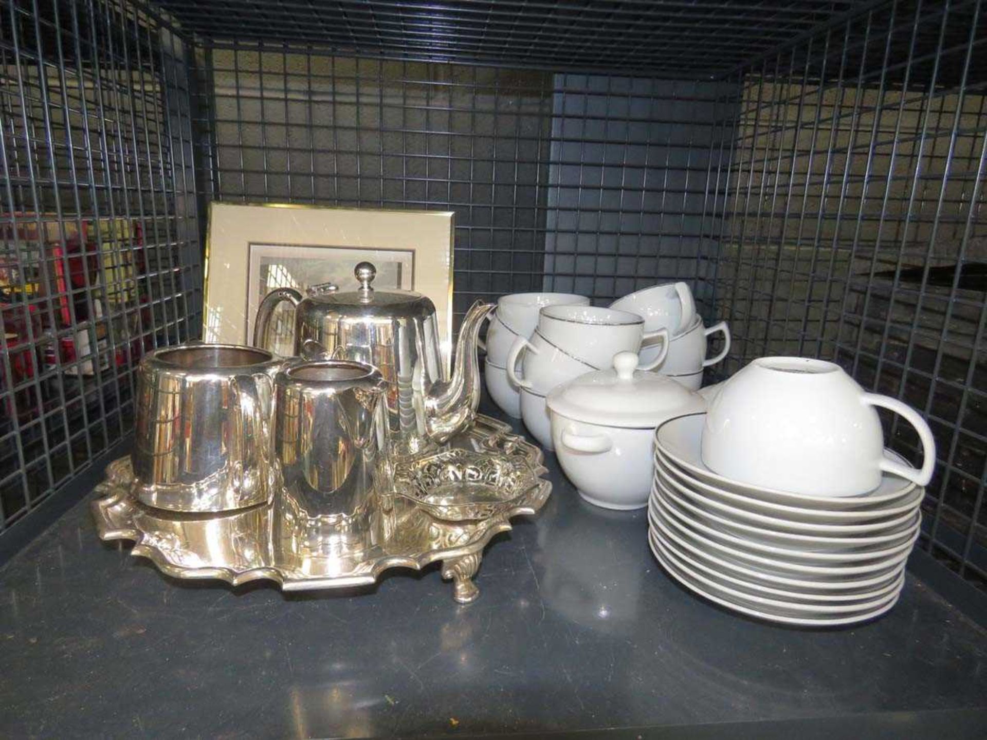 Cage containing an urban engraving, silver plated tea service, silver rimmed cup, saucers and 2