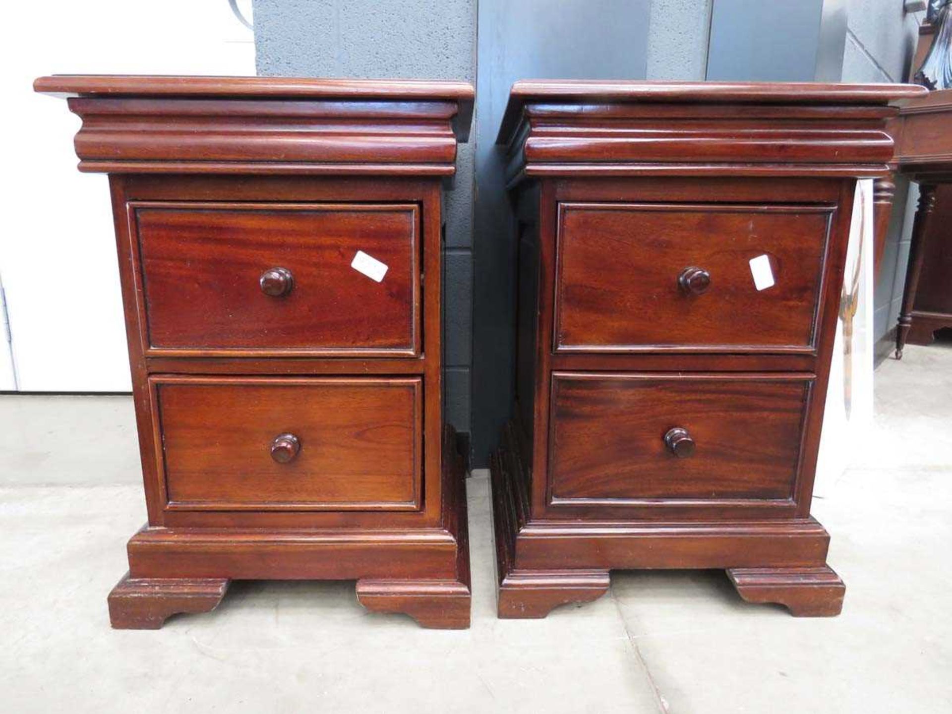 Pair of dark wood two drawer bedside cabinets