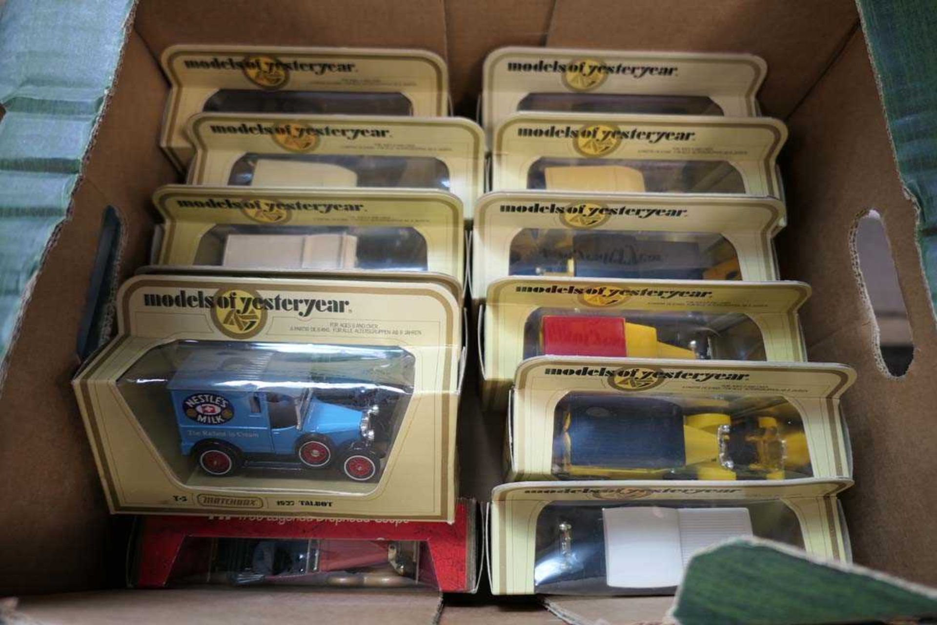 Box containing a selection of Matchbox models and Yesteryear commercial die cast vehicles