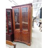 Glazed pine bookcase with cupboard under