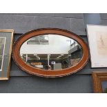 Oval bevelled mirror in oak frame