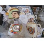 Box containing commemorative mugs and a tea towel