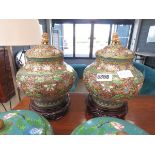 Pair of floral patterned lidded pots with temple dog finials