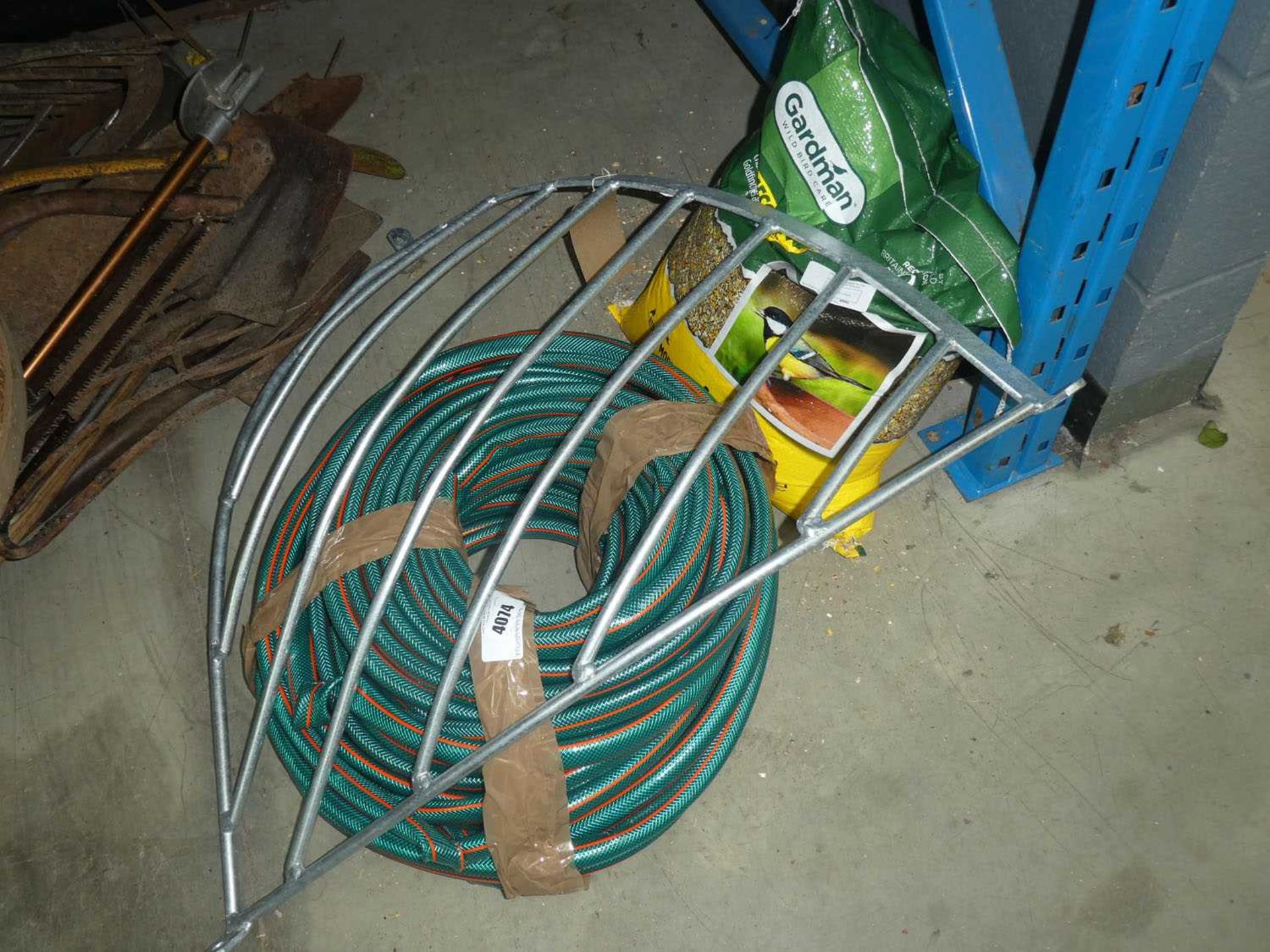 +VAT Reel of hose pipe, bag of bird seed and hay rack